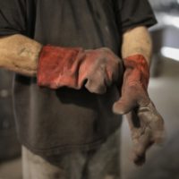 anonymous worker in heavy duty gloves