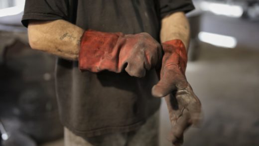 anonymous worker in heavy duty gloves